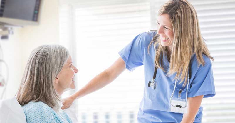 Nurse smiling talking with patient