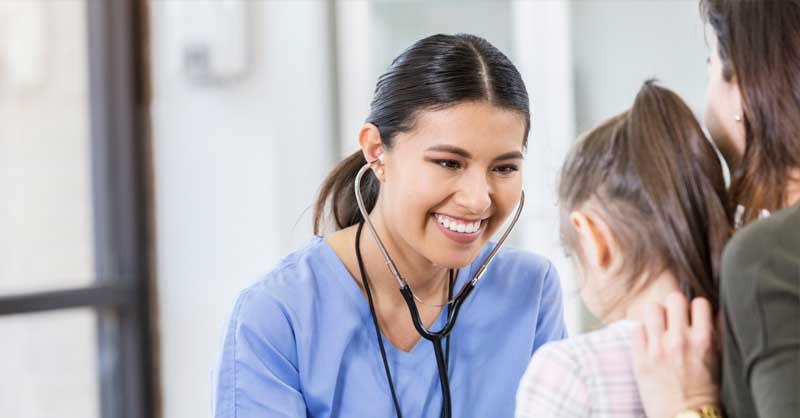 nurse with stethoscope helping child patient